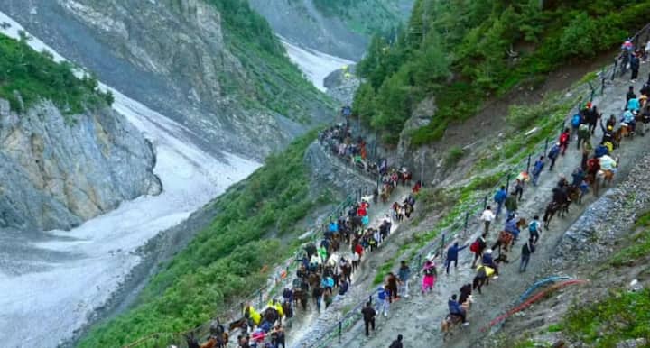रात के समय बालटाल से पवित्र गुफा तक रोशनी से जगमगाता ट्रैक, LED लाइटों के बीच सुरक्षित ट्रेकिंग करते श्रद्धालु. सूचना बोर्ड, आधुनिक सुविधाएं और व्यवस्थित यात्रा का दृश्य. यथार्थवादी, सिनेमैटिक, बिना टेक्स्ट.