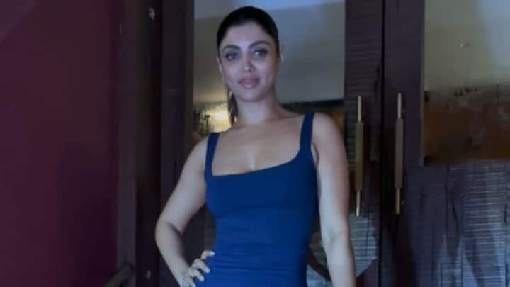 Akanksha Puri spotted in Bandra wearing a dark blue, sleeveless maxi dress with a square neck and a high thigh slit.