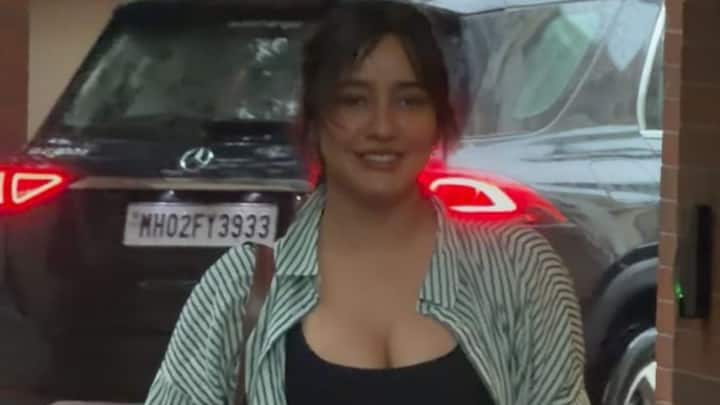 Neha Sharma spotted in Bandra, Mumbai, wearing a green and white striped oversized shirt over a black gym outfit.
