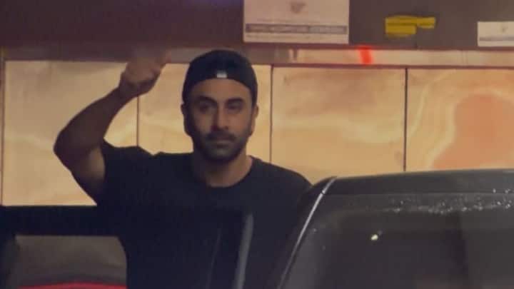 Ranbir Kapoor snapped in Mumbai, wearing a black crewneck shirt and a matching baseball cap.