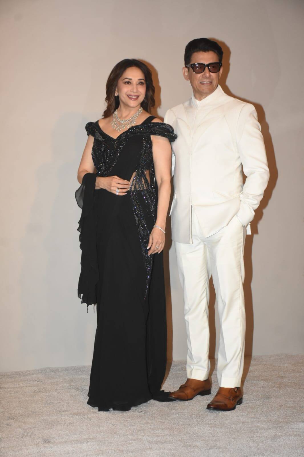 Madhuri Dixit arrived at this event wearing a black stylish gown, in which she looked very beautiful and elegant. Her husband Dr. Shriram Nene looked quite handsome in white blazer and black pants.