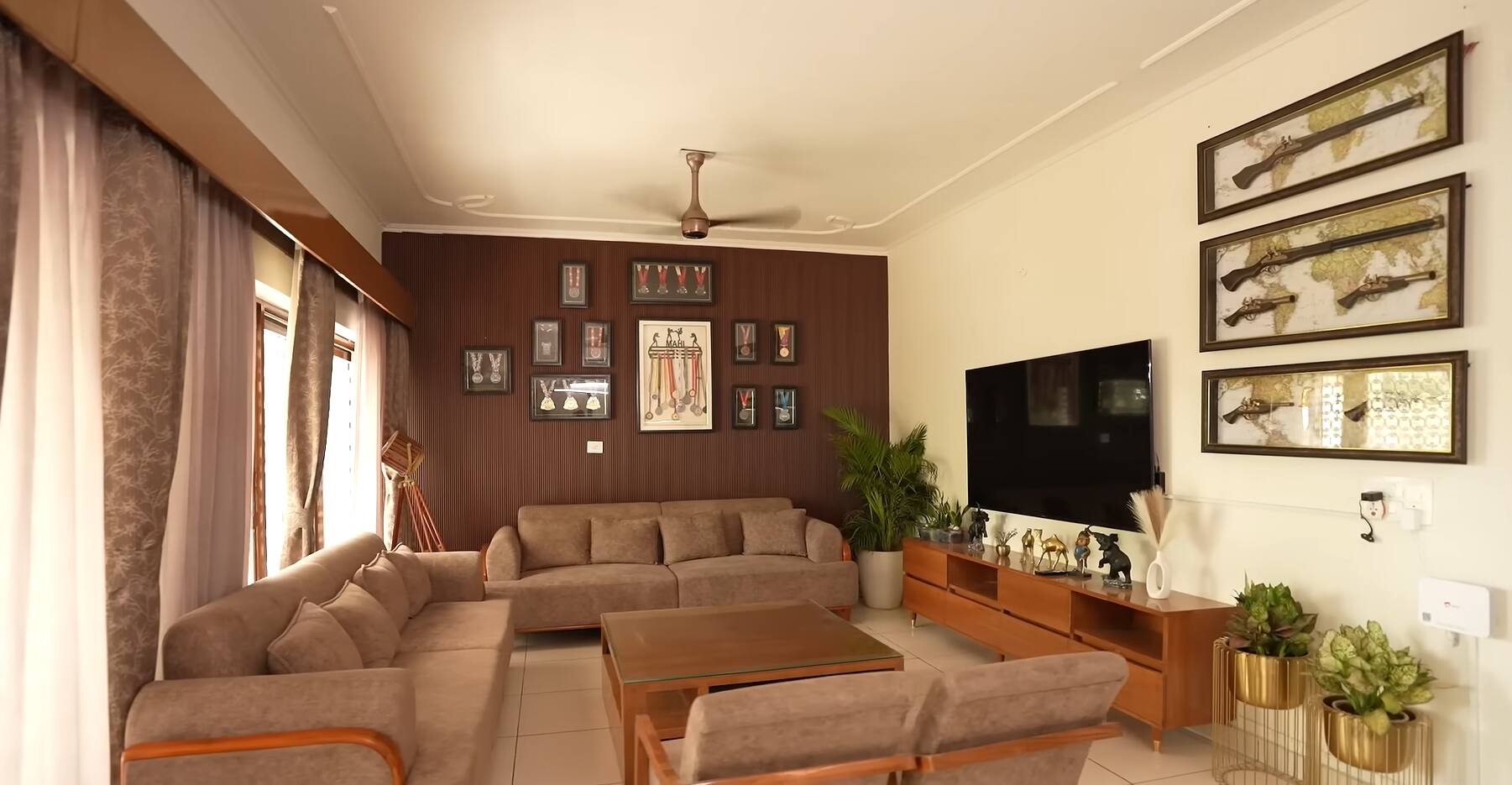 There are many medals decorated on a wall in the house. During the conversation, Rajat Dalal said that these belonged to him and his wife Mahi.